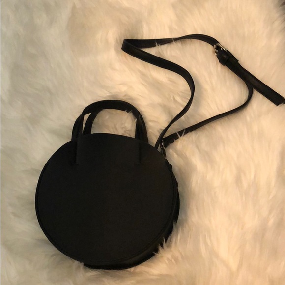 Urban Outfitters Handbags - Black circular crossbody bag.